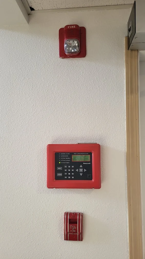 Wall-mounted alarm panel, horn strobe and manual call point